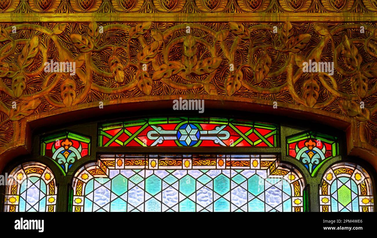 Part of a stained glass window and decoration of carved wood. Old