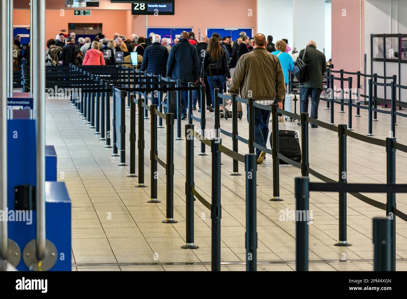 London, United Kingdom - February 05, 2019: View from back to group of passengers walking to the gate before boarding the airplane at London Luton, 5t Stock Photo