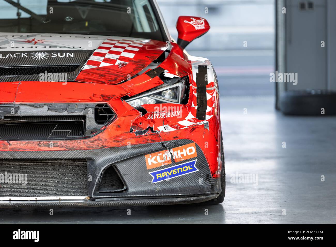 Oschersleben, Germany, April 9, 2023: Front view of scratched wrecked bumper red racing Cupra Cupra Leon Competition Motorsport Arena garage box race Stock Photo