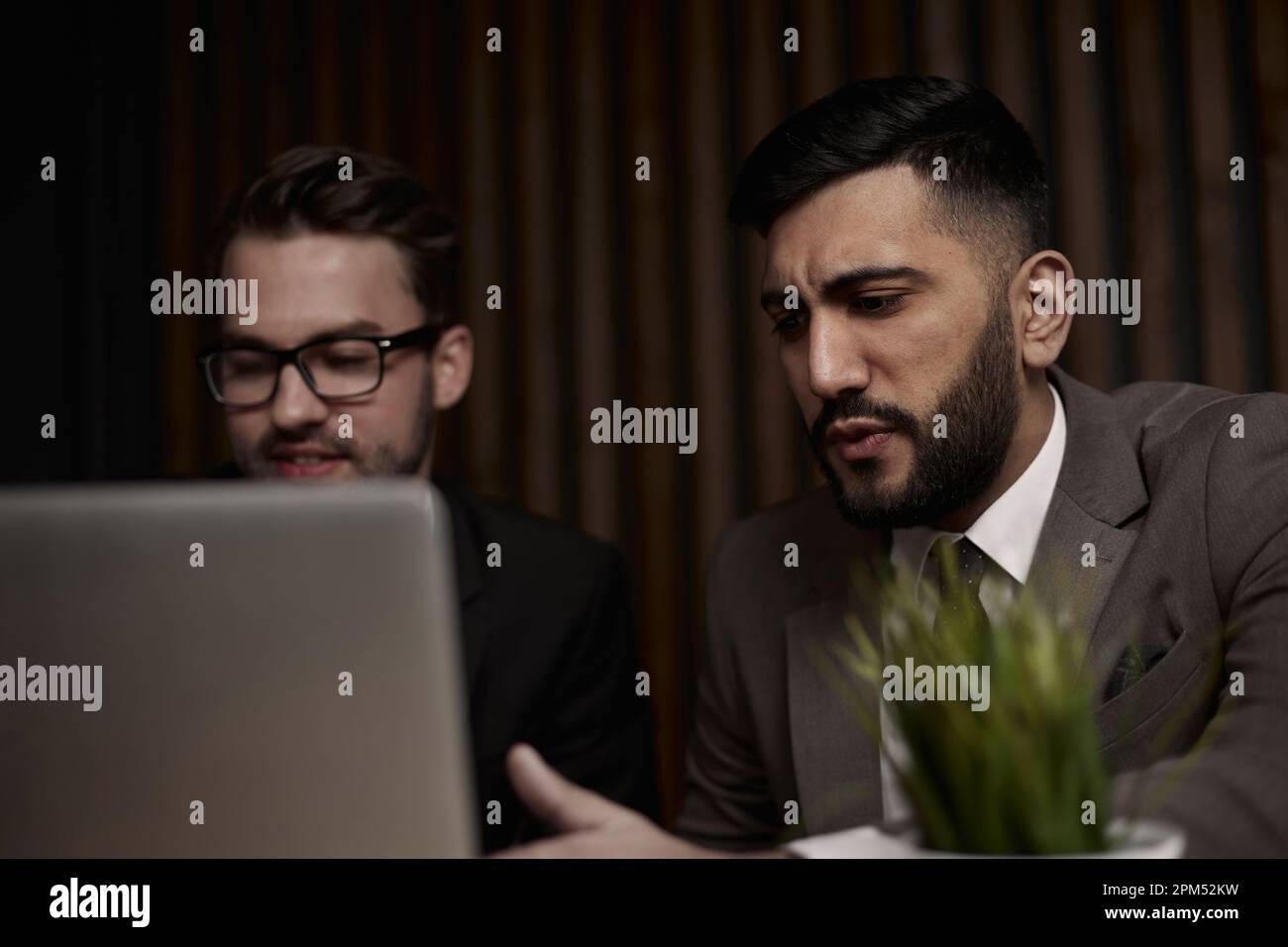 Two men discussing company growth, looking at rising graph on la Stock ...