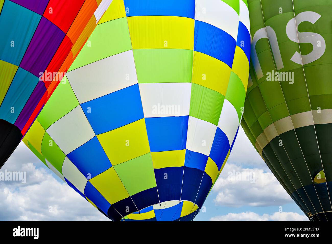 Colorful hot air balloon flying over blue sky with white clouds Stock ...