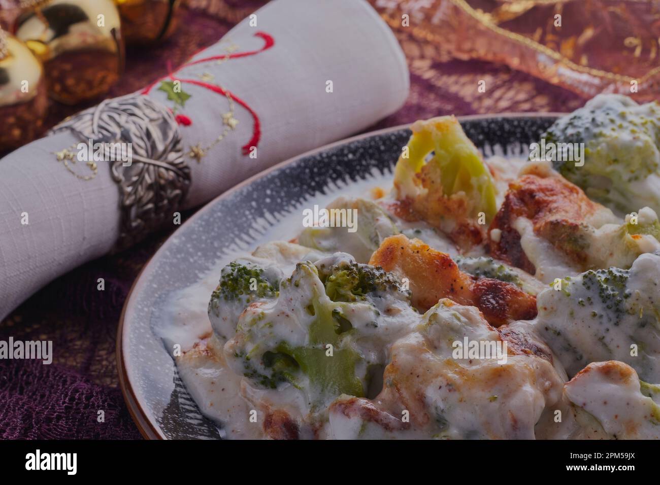 Christmas vegetarian broccoli bake with decorations at the side. Stock Photo