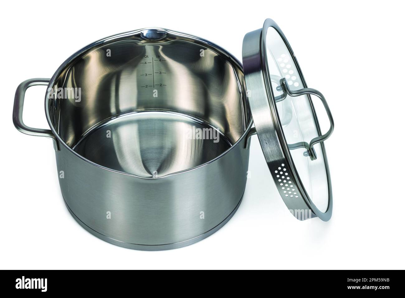 Close-up view of open 4 liter stainless steel saucepan with glass lid on white background. Sweden. Stock Photo
