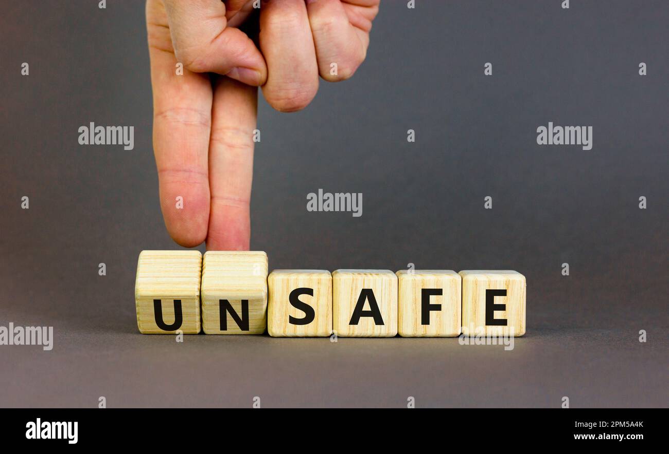 Safe or unsafe symbol. Concept word Safe Unsafe on wooden cubes