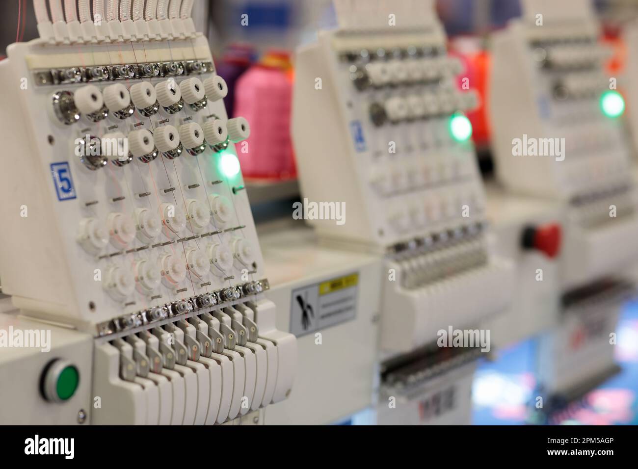 Multi head automatic embroidery machine close up. Selective focus Stock