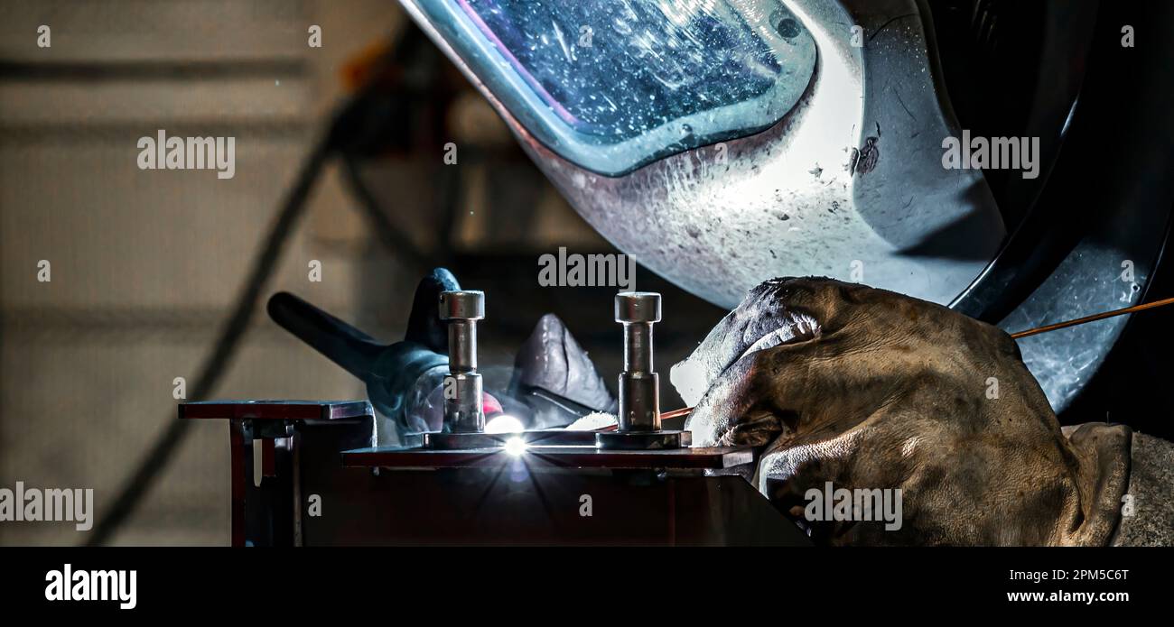 View of welder at work in a workshop, France Stock Photo