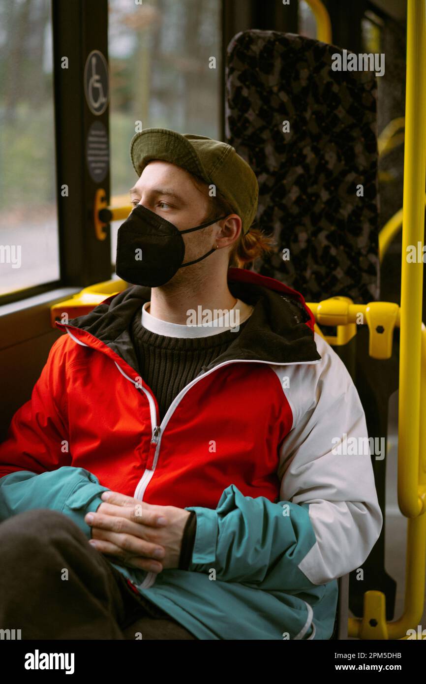 A young man in mask in public bus in Berlin Stock Photo Alamy