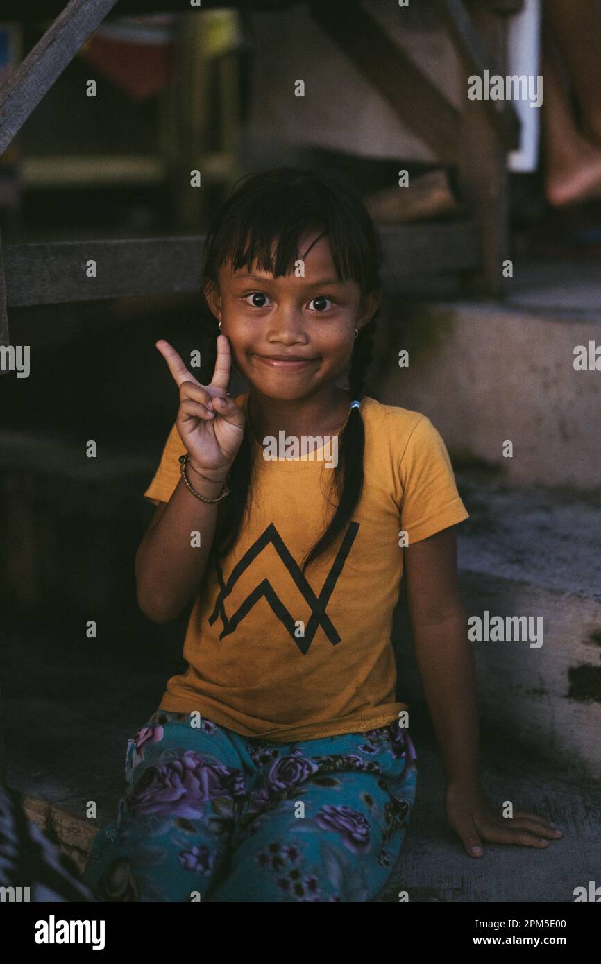 Little Balinese girl smiling shows peace. Stock Photo