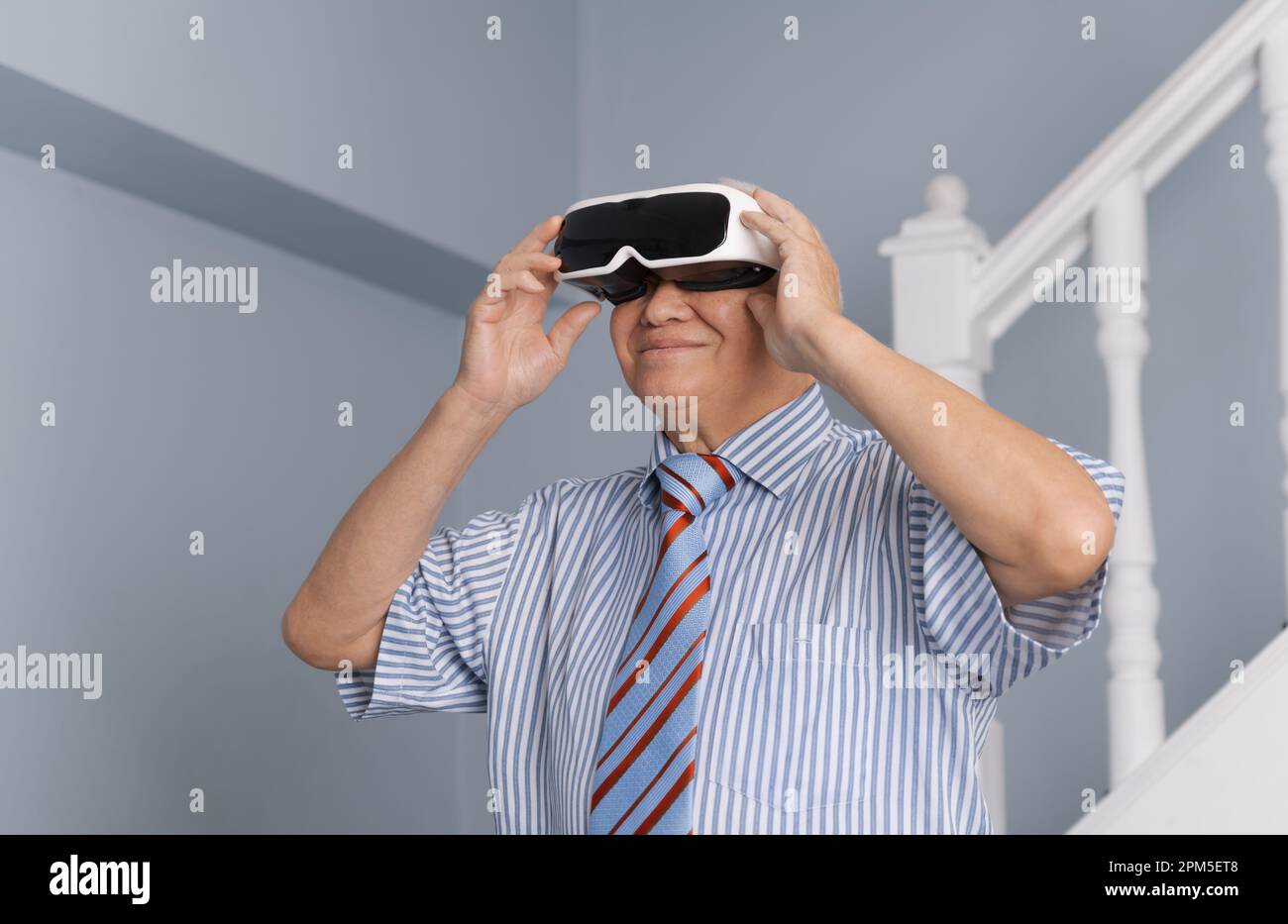 Senior man having experience virtual reality with VR headset device
