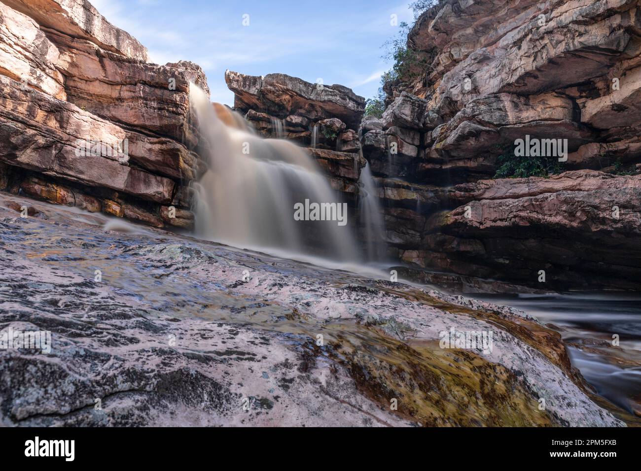 Waterfall among rock walls in long exposure Stock Photo - Alamy