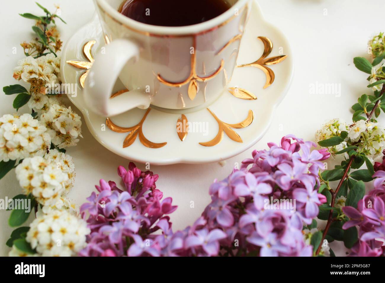 Decorative Arrangement of Flowers and Antique Dishes Stock Photo