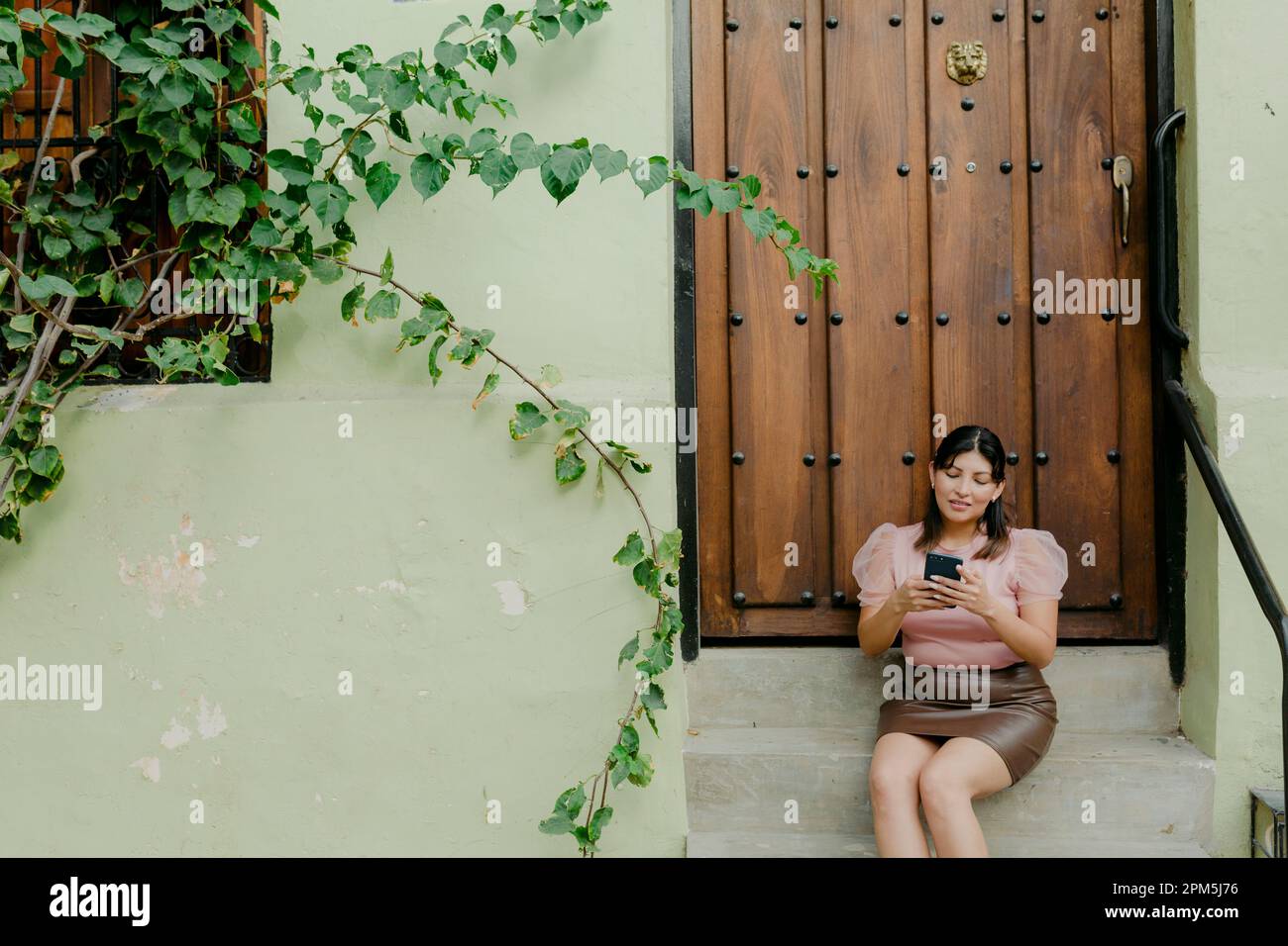 Woman texting on the phone and laughting Stock Photo