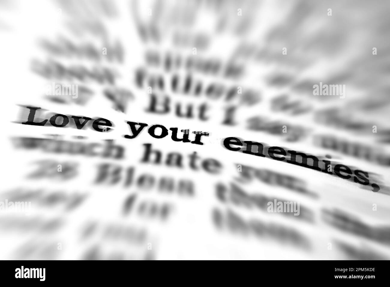 Detail closeup of New Testament Scripture quote Love Your Enemies Christian Scriptures with zoom blur Stock Photo