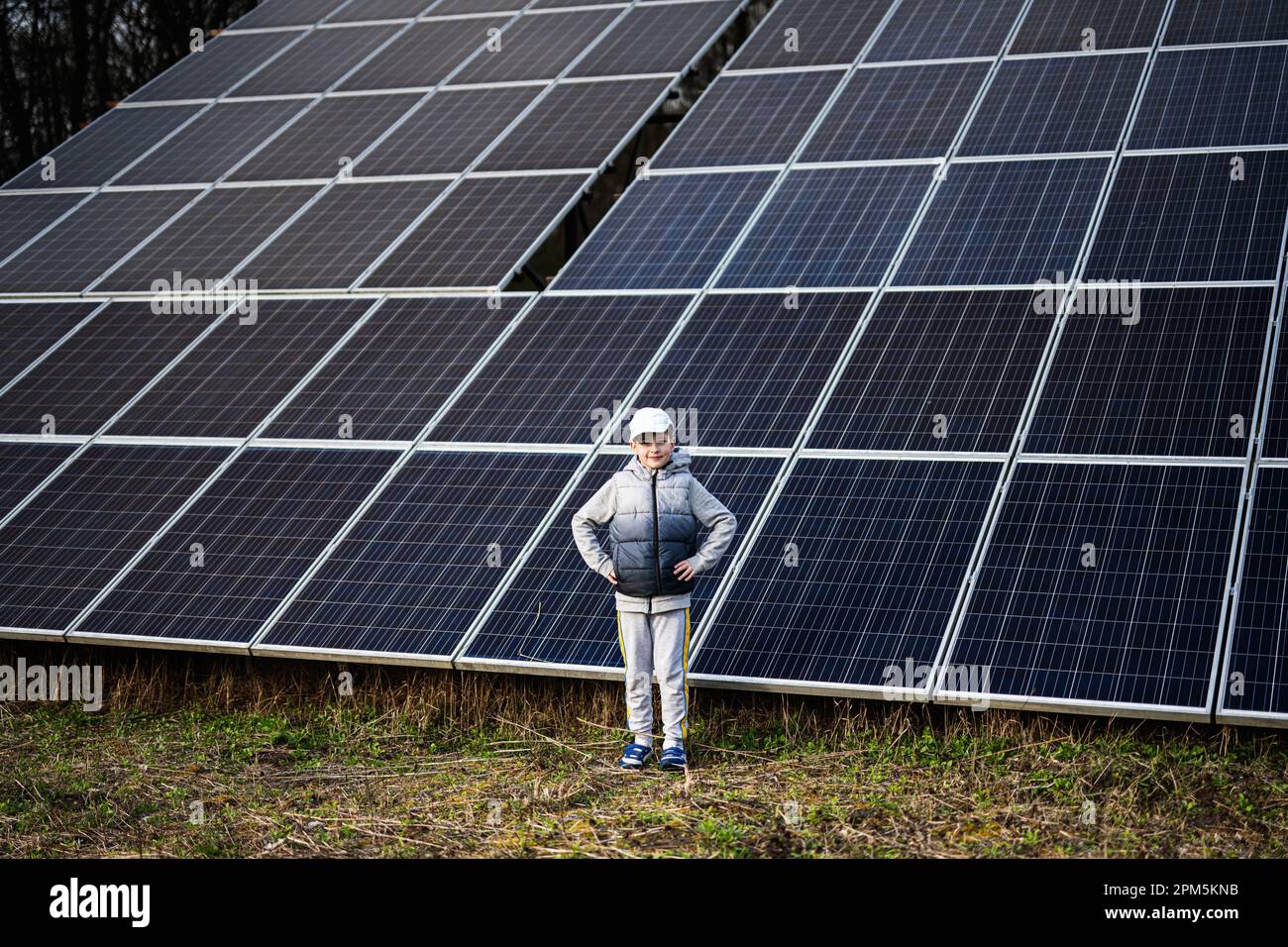 Boy child on the background of solar panels. Eco energy Stock Photo Alamy
