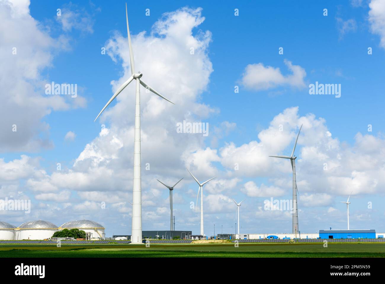 Tall wind turbines in a industrial park on a clear summer day Stock Photo