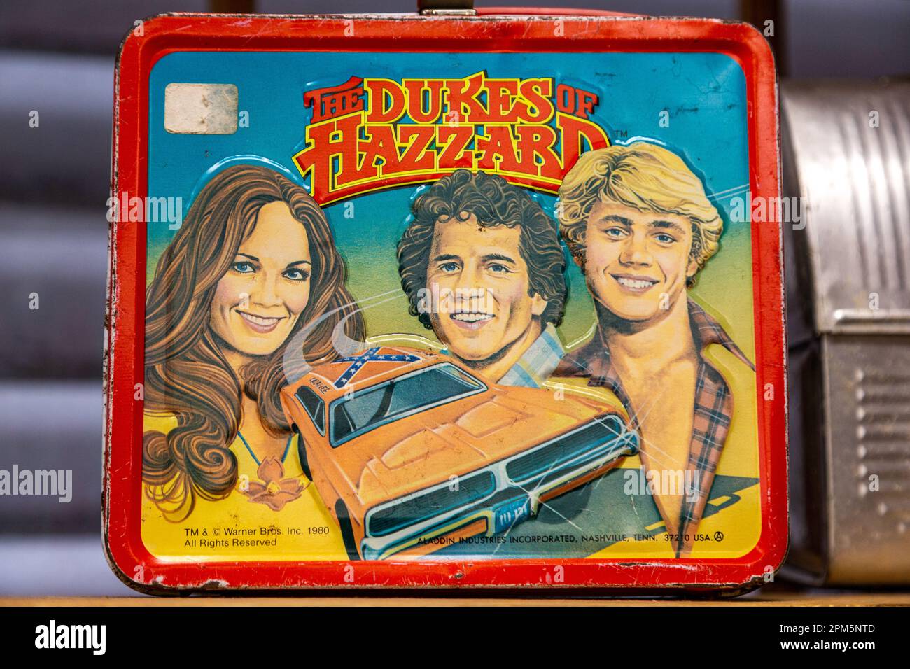 A photo of a vintage 1980 lunchbox featuring the General Lee, Daisy, Luke and Bo Duke, the television series Dukes of Hazzard. Stock Photo