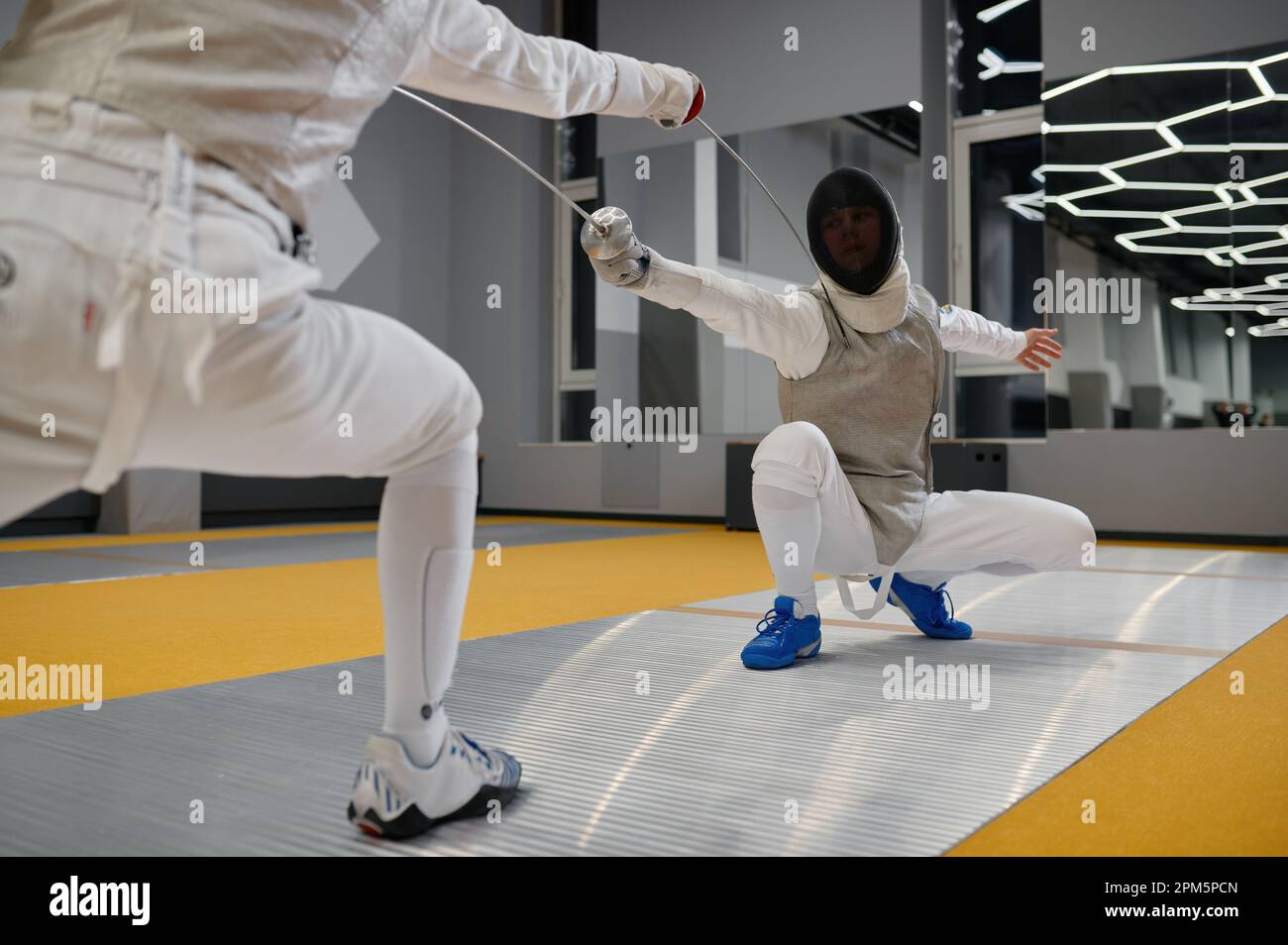 Duel of fencers during fencing match, training lesson at martial art