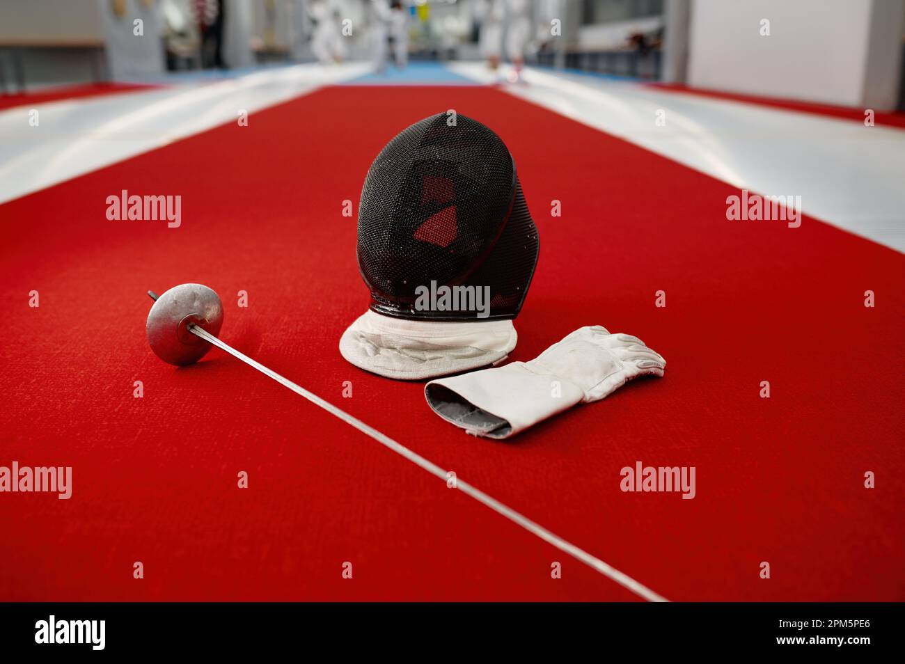 Fencing sword, protective helmet with mask and leather gloves Stock