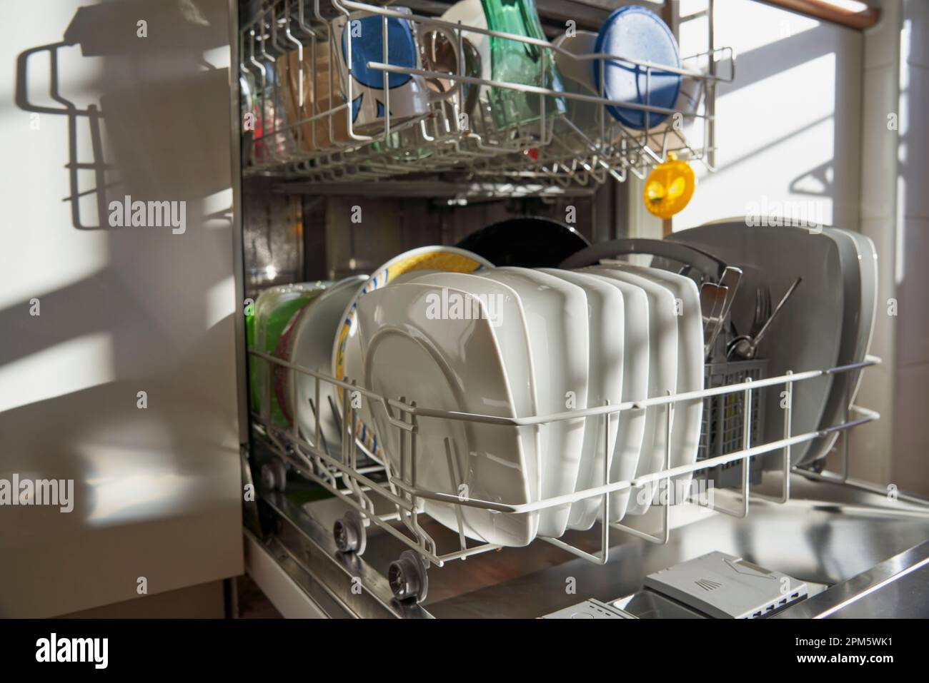 Side view of dishes and utensils in a dishwasher in a Spanish kitchen