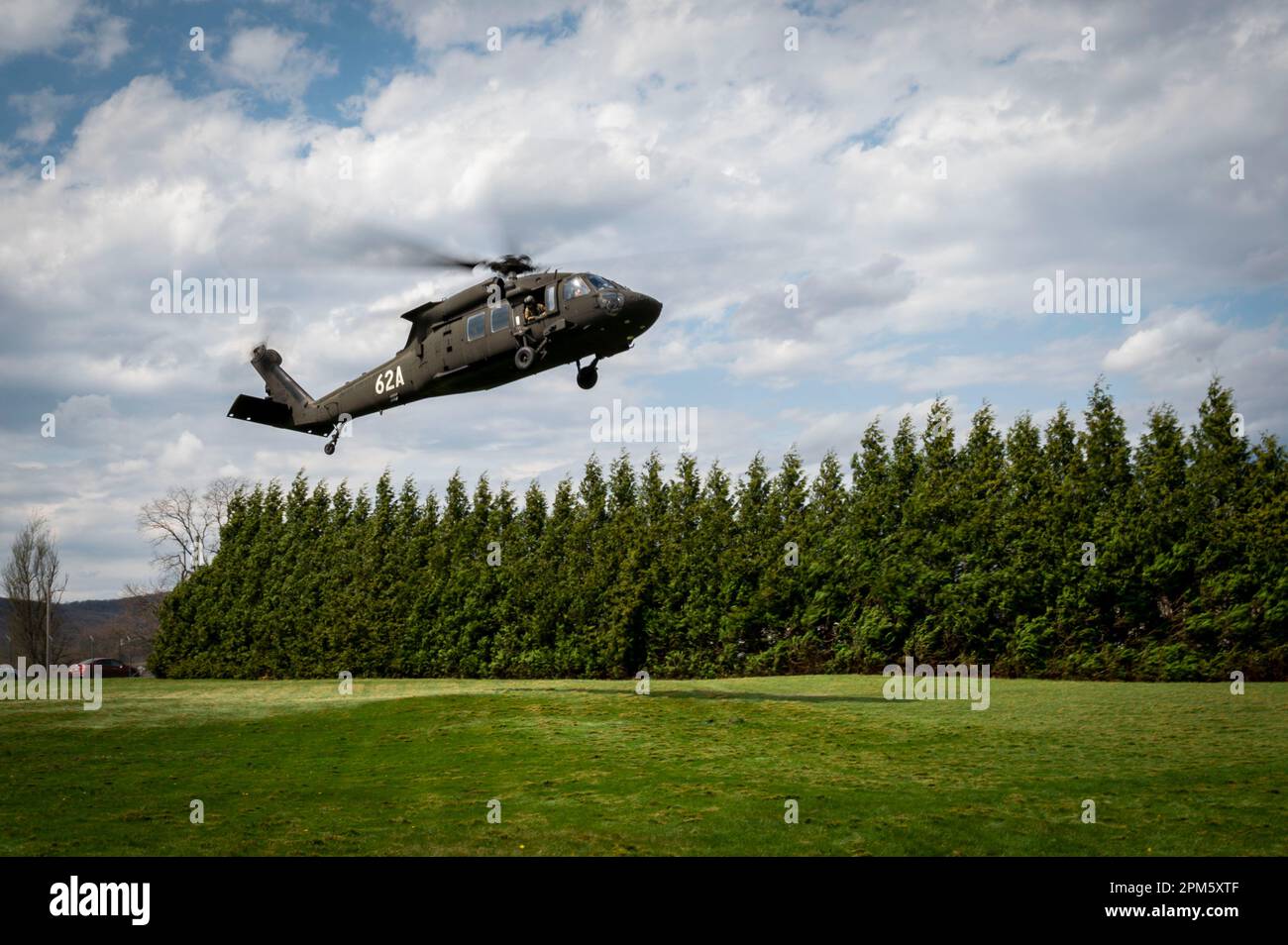 A UH-60M Black Hawk helicopter belonging to the U.S. Army Aviation Center of Excellence prepares to land during a medical evacuation demonstration as part of U.S. Army Medical Readiness Development Command’s Capability Days event, Fort Detrick, Md., April 6, 2023. Medical development industry representatives joined the USAMRDC team here to learn about the continuum of combat casualty care, from moment of injury through aerial medical evacuation, and the capabilities USAMRDC and its subordinate units are currently developing for the U.S. Joint Force. The USAMRDC Capability Days event is the cul Stock Photo