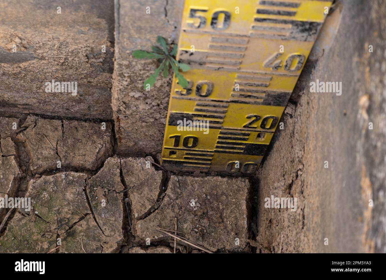 A water volume meter is seen inside a dry irrigation canal. Catalonia is in a state of exceptionality after 32 months of drought due to lack of rain. The Catalan Government applies special measures to avoid greater restrictions on drinking water. Stock Photo