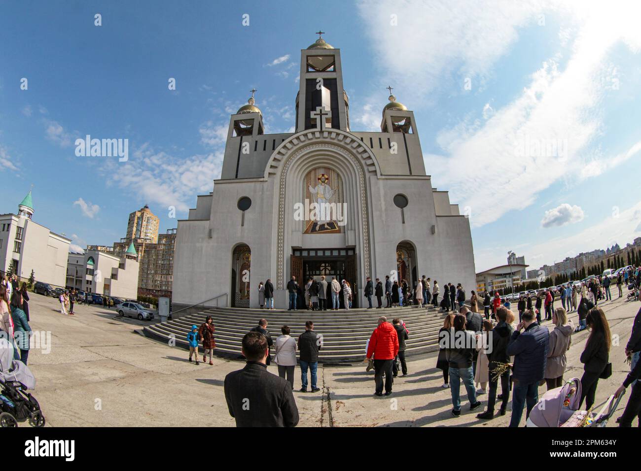 KYIV, UKRAINE - APRIL 09, 2023 - People stand outside the Patriarchal Cathedral of the Resurrection of Christ, Kyiv, capital of Ukraine. Stock Photo