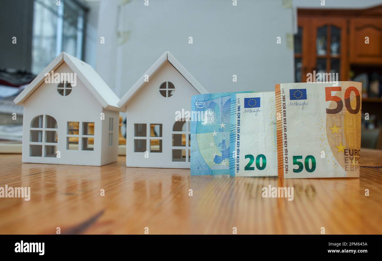 euro notes and tiny white houses. concept, investing in Real state Stock Photo