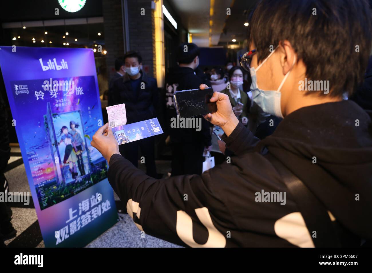 SHANGHAI, CHINA - MARCH 25, 2023 - People take photos of movie posters