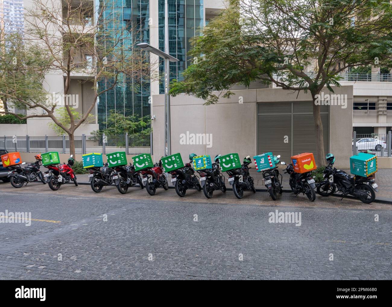 Dubai, UAE April 1, 2023 Row of food delivery service motor bikes in