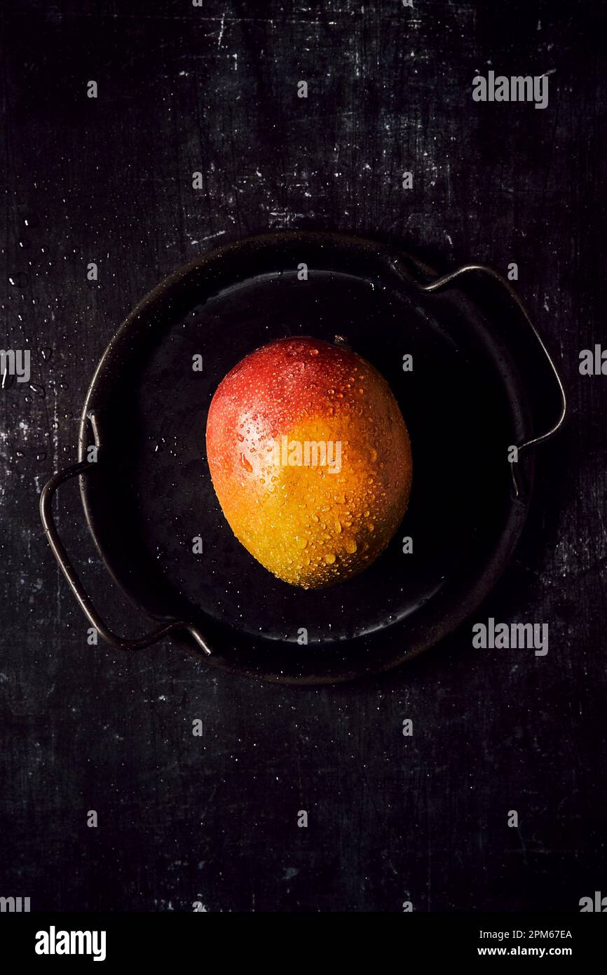Fresh Mango on black tray and black background Stock Photo