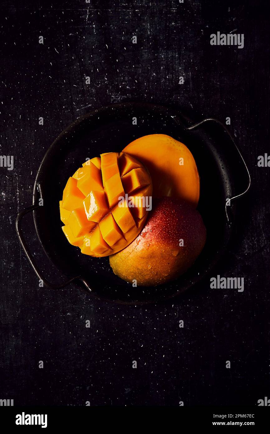 Fresh Mango on black tray and black background Stock Photo