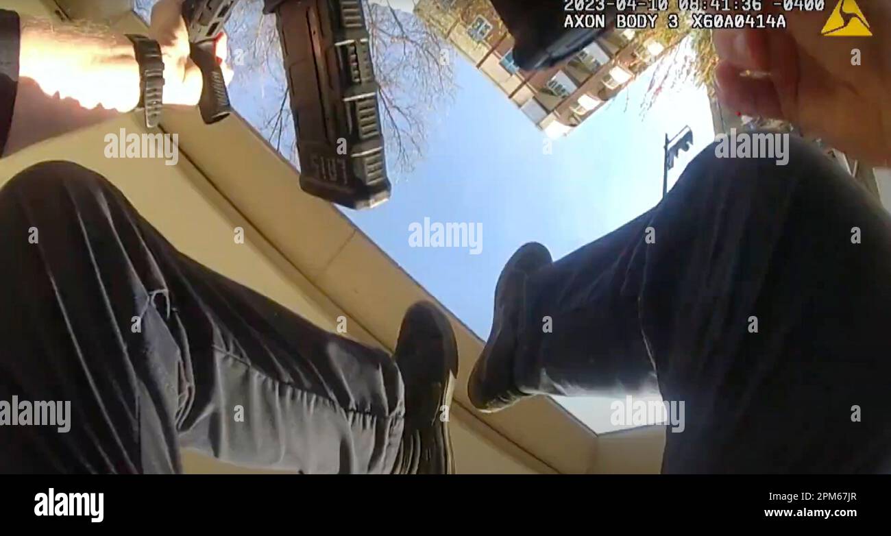 This screen grab taken from the body cam video of Louisville Metro Police  Department Officer Cory Galloway shows Galloway falling to the ground, with  legs in the air, as he and partner