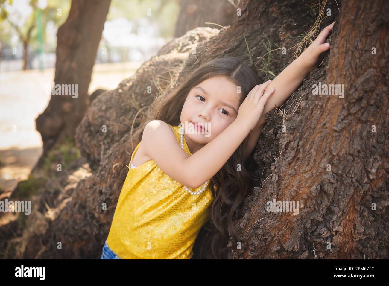 Expressions of happiness, beautiful blonde girl lying on a tree, model  girl. children's day theme Stock Photo - Alamy, image size:1300x956
