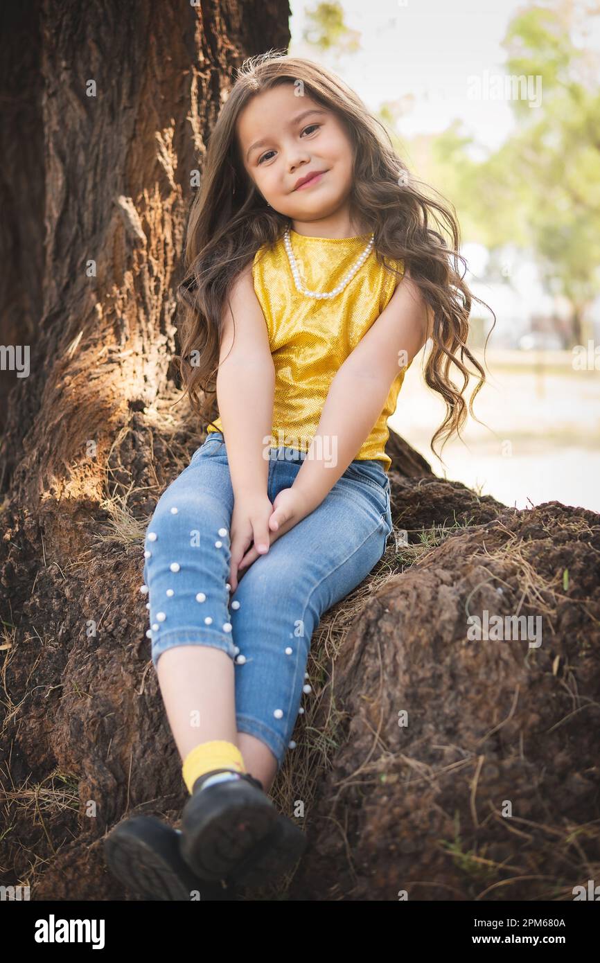 Girl sitting in a tree hi-res stock photography and images - Alamy, image size:866x1390