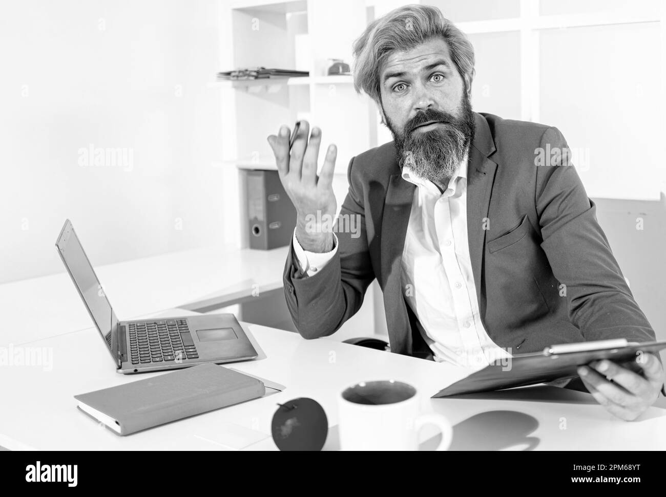 Boring job. Portrait of young man sitting at his desk in the office