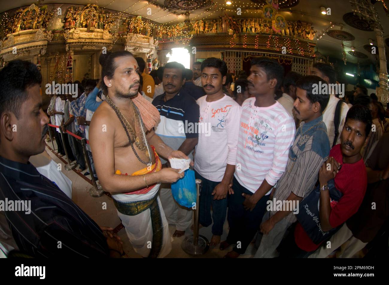 Priest with devotees at Deepavali ceremony, Sri Veeramakaliamman Temple, Little India, Singapore Stock Photo