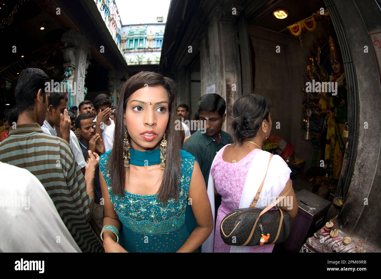 Woman in sari among devotees at Deepavali ceremony, Sri Veeramakaliamman Temple, Little India, Singapore Stock Photo