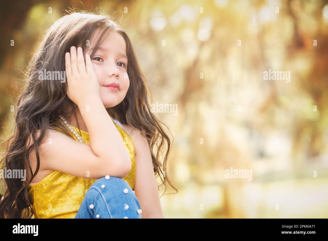 Expressions of happiness. blonde girl sitting in a tree smiles placidly. model girl. children's day theme. Stock Photo