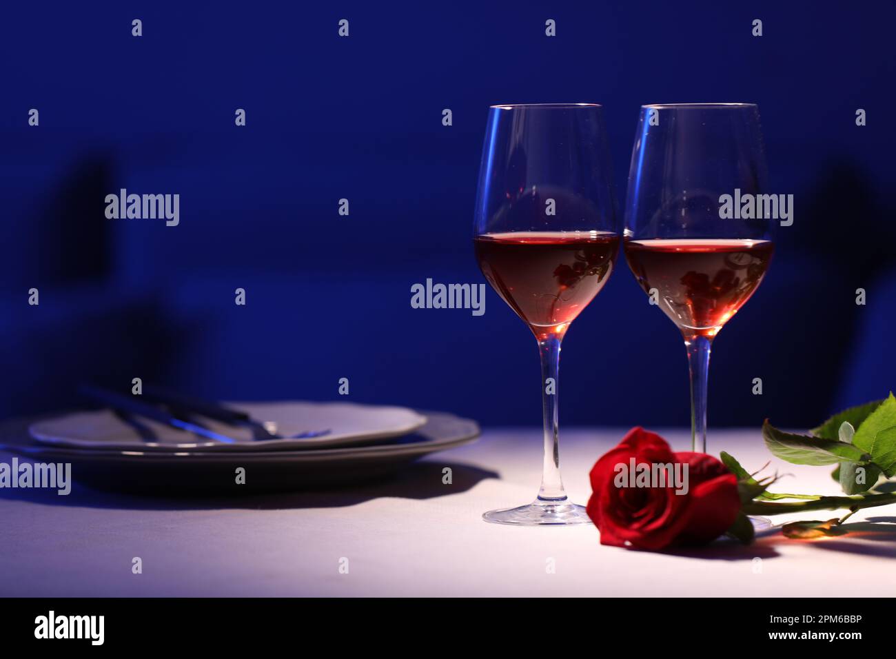 https://c8.alamy.com/comp/2PM6BBP/beautiful-table-setting-with-glasses-of-wine-and-rose-in-dark-room-romantic-dinner-for-valentines-day-2PM6BBP.jpg