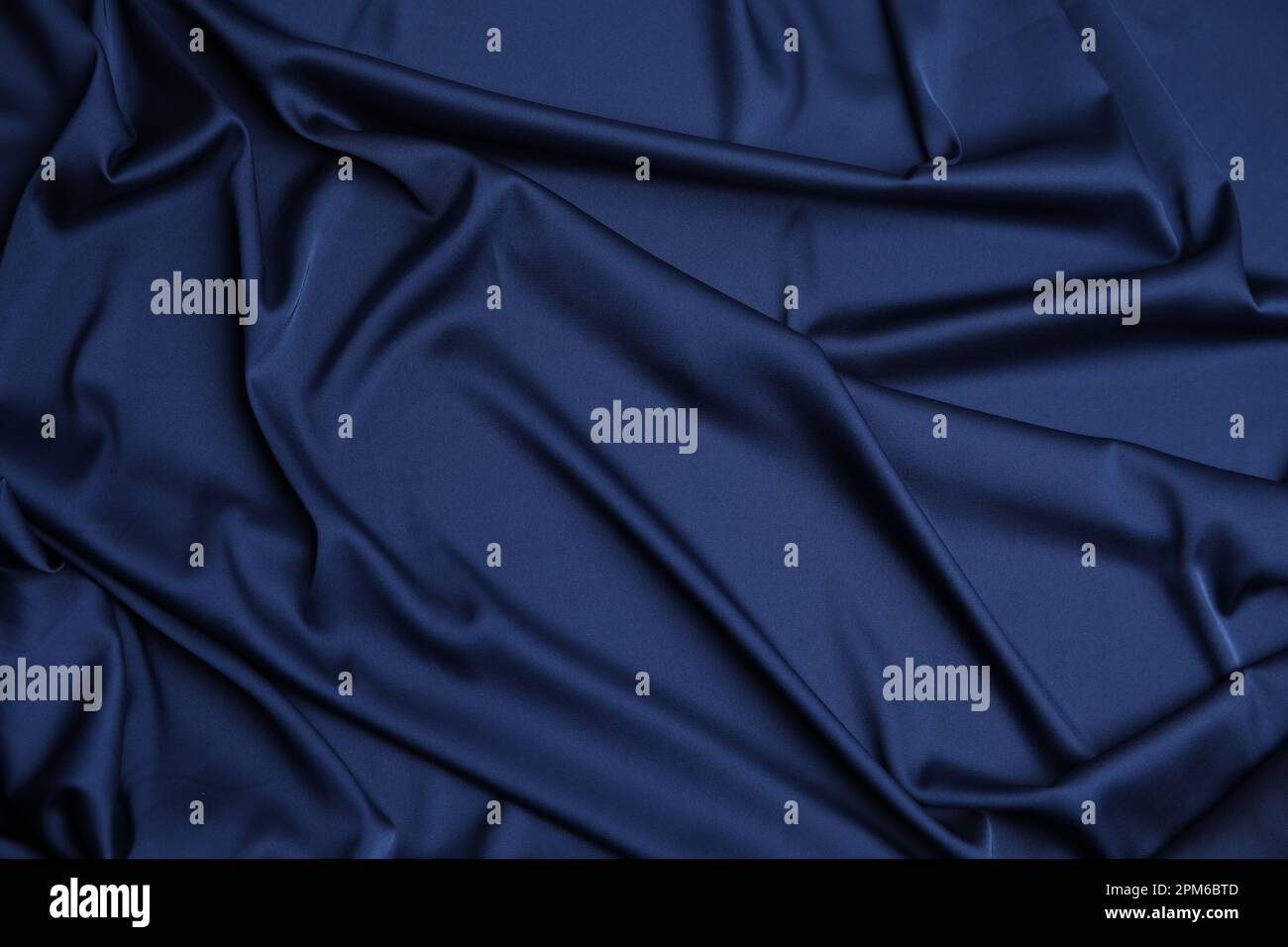 Crumpled dark blue silk fabric as background, top view Stock Photo - Alamy