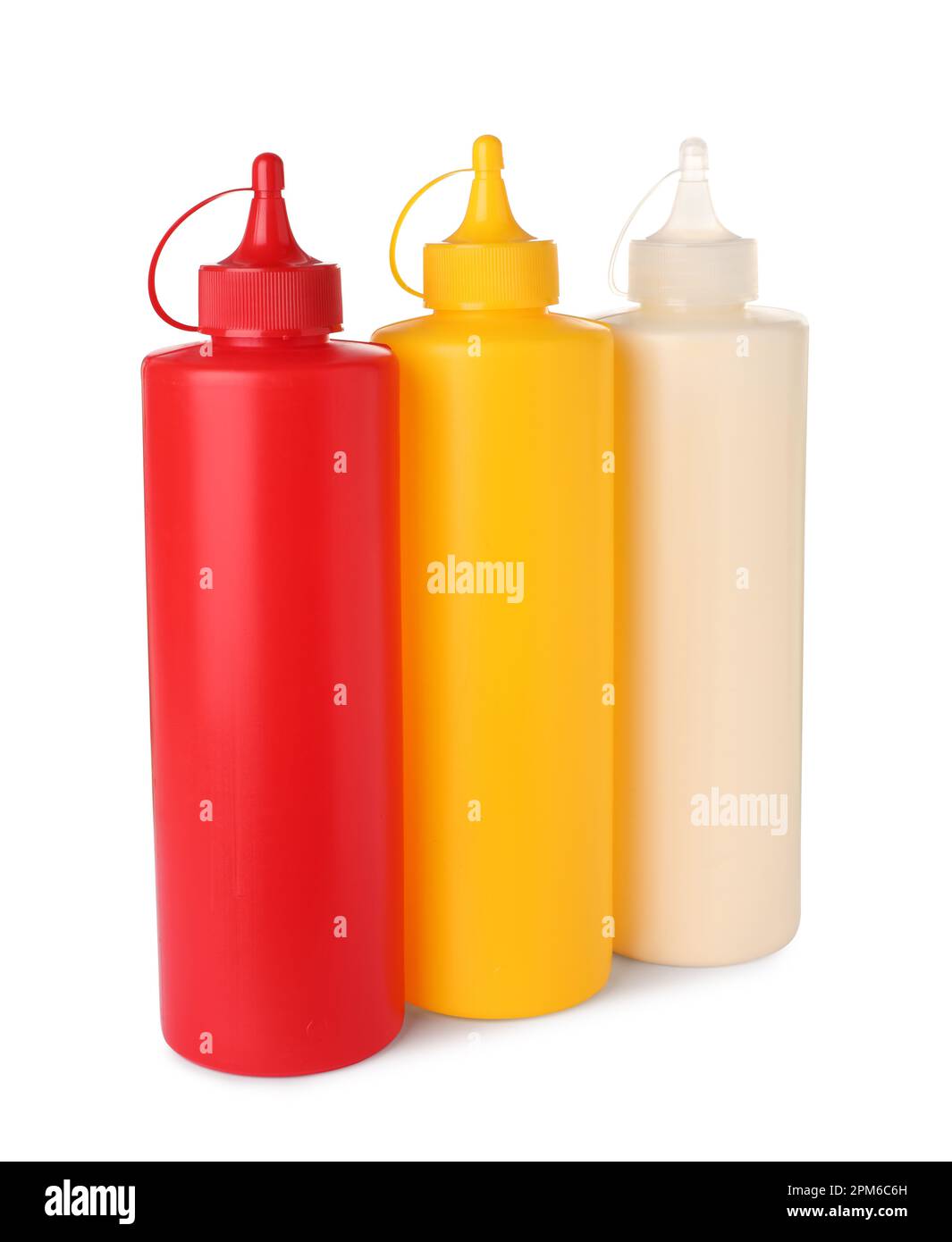 Plastic bottles of tasty mayonnaise, ketchup and mustard on white
