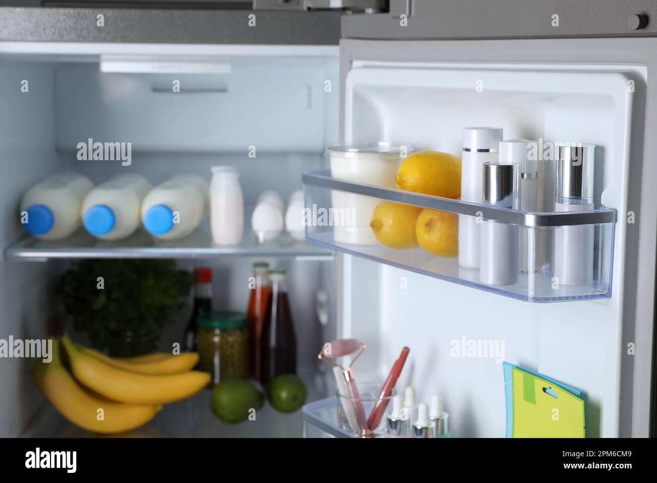 Storage of cosmetics in refrigerator door bins next to groceries Stock Photo Alamy