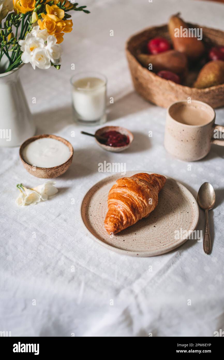 Breakfast scene with croissant, coffee, yogurt and fruit Stock Photo ...