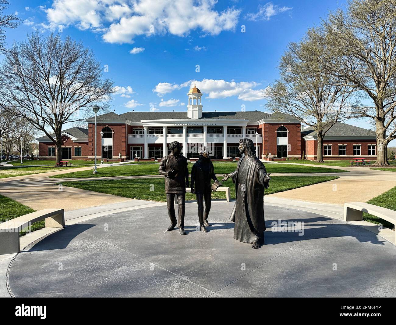 Olathe, KS - April 11, 2023: Statues of Jesus with MNU students outside of the Cunningham Center at MidAmerica Nazarene University Stock Photo