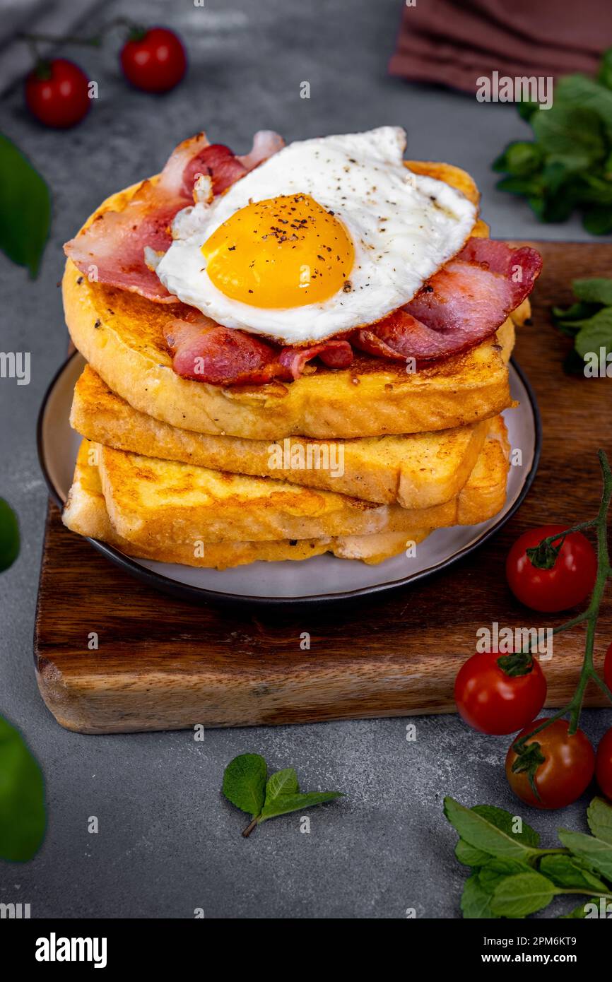 A Stack Of Eggy Bread Slices Topped With Fried Bacon And Egg Stock A Stack Of Eggy Bread Slices Topped With Fried Bacon And Egg Stock