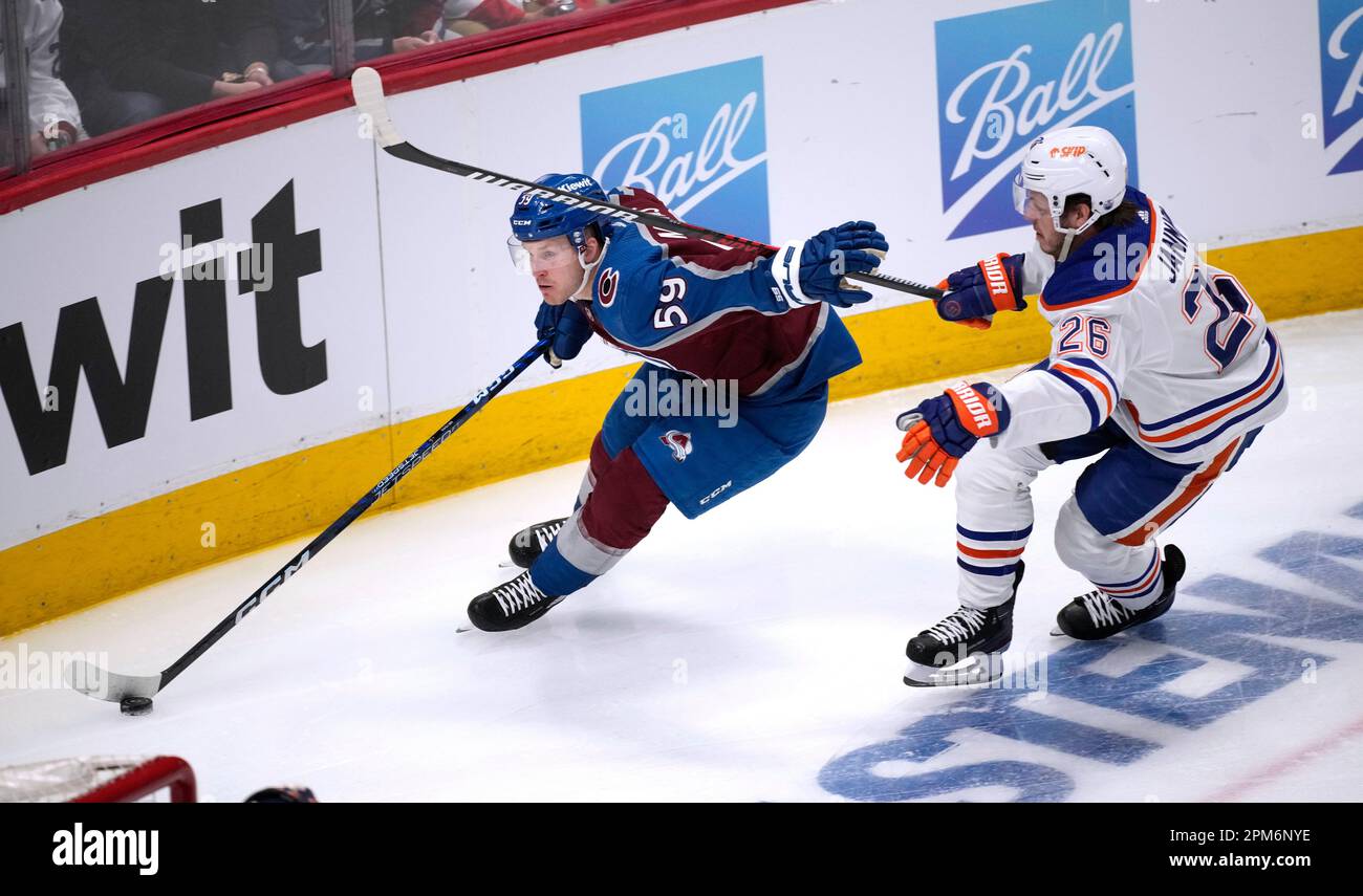 Colorado Avalanche center Ben Meyers, left, drives past Edmonton Oilers