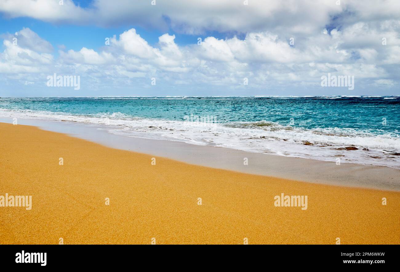 Ocean waves breaking onto a sand beach Stock Photo