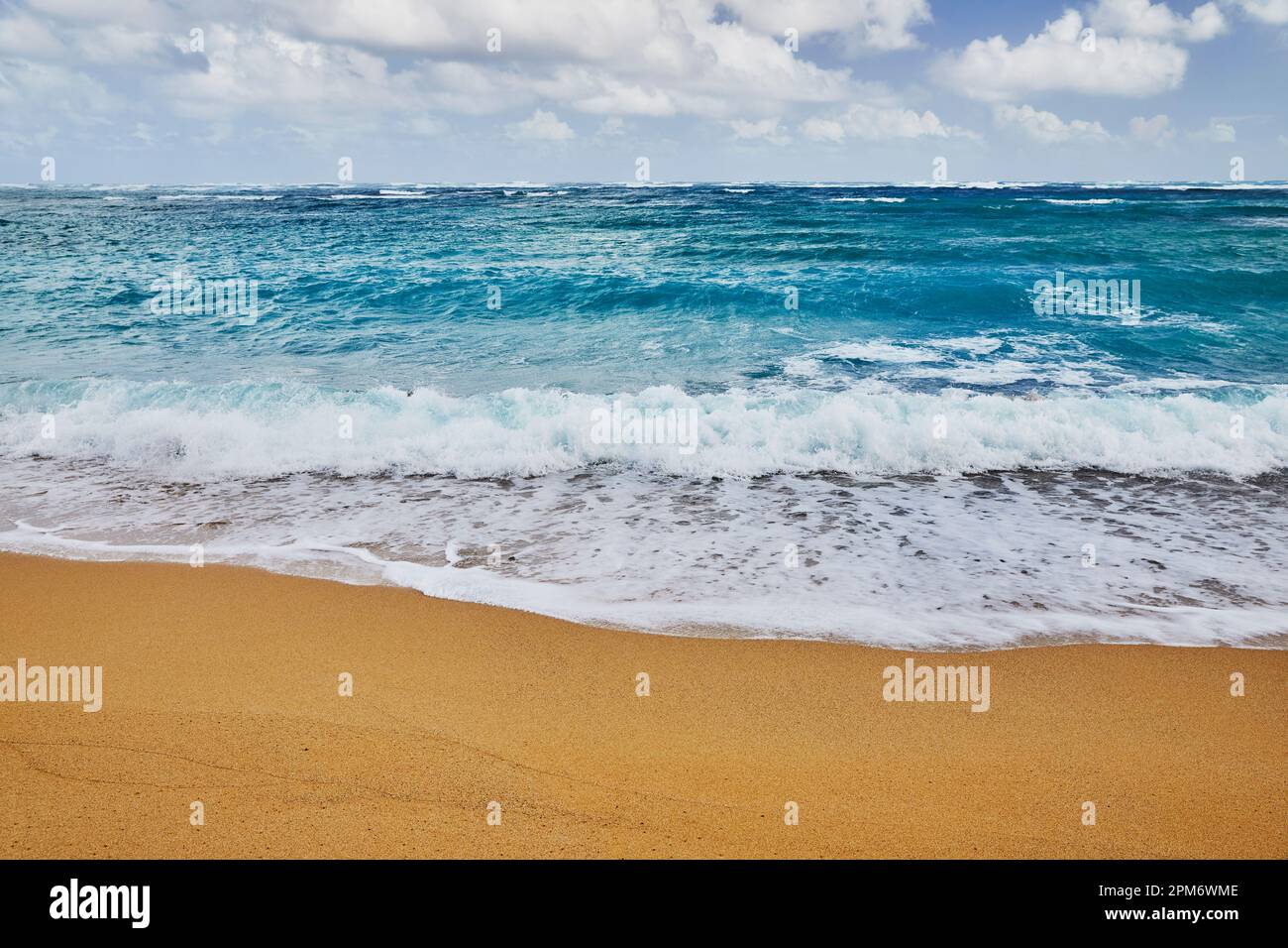 Ocean waves breaking onto a sand beach Stock Photo