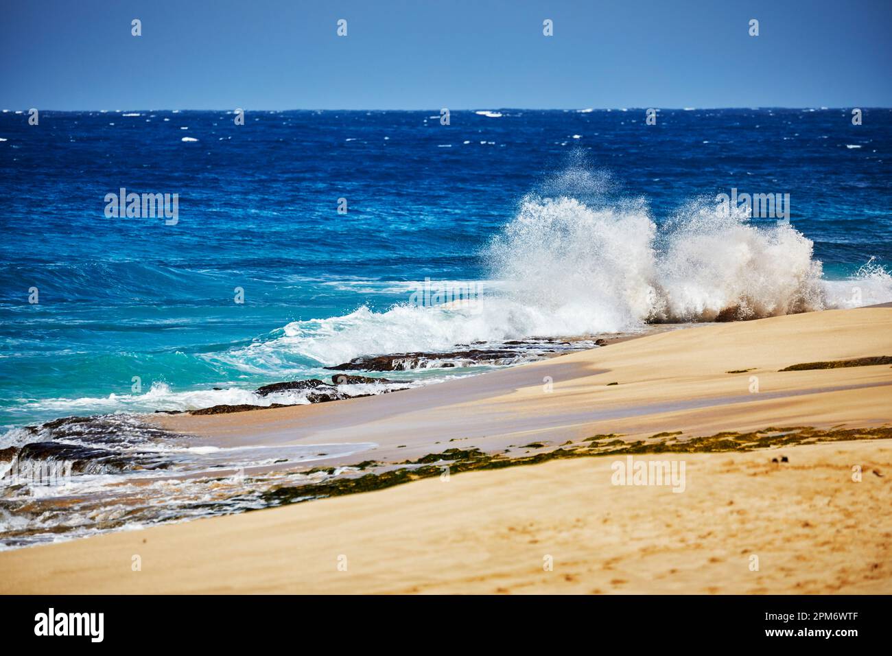 Ocean waves breaking onto a sand beach Stock Photo