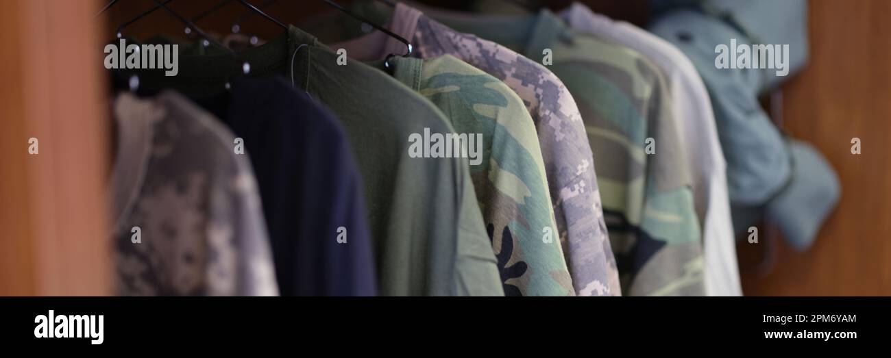 Collection of military uniform tshirts in wardrobe Stock Photo Alamy
